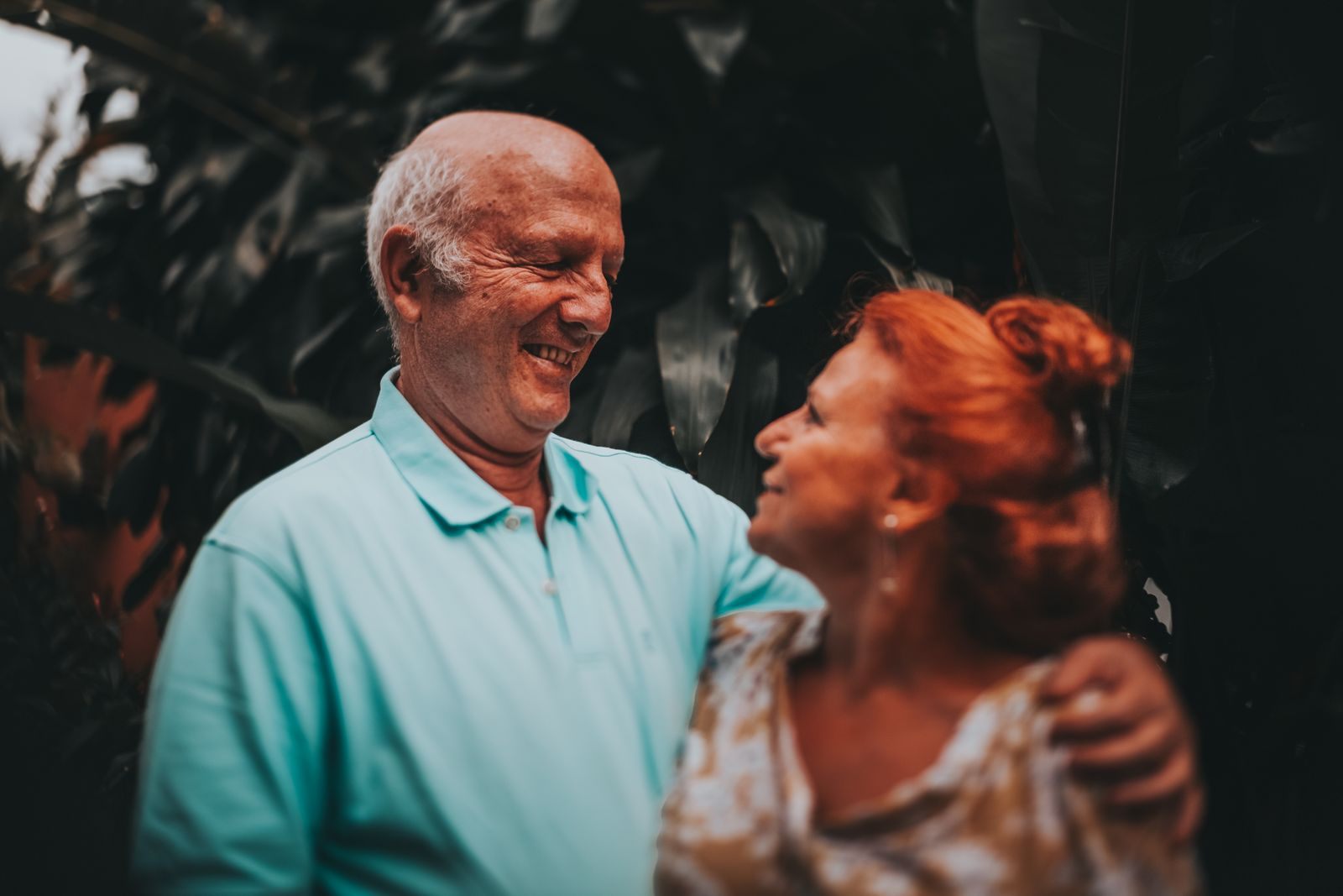 Smiling older couple sharing a laugh outdoors
